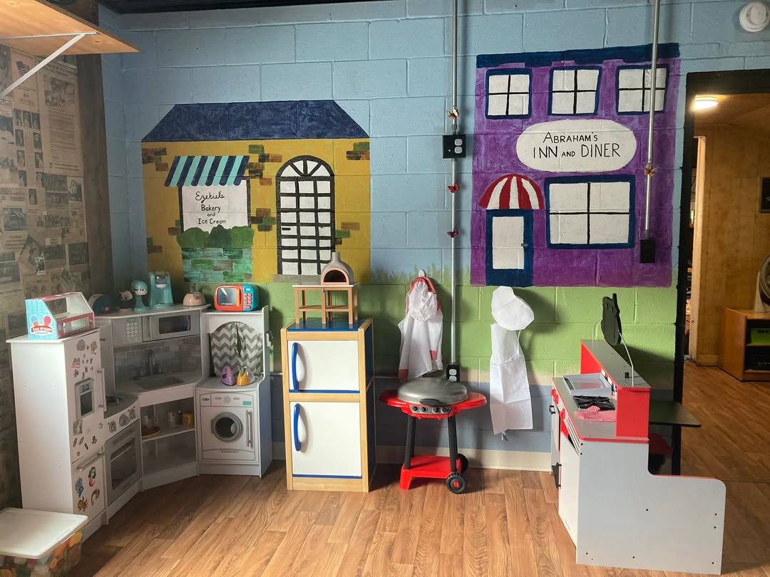 The play kitchen and town pretend-play corner at Butterfly Blessings